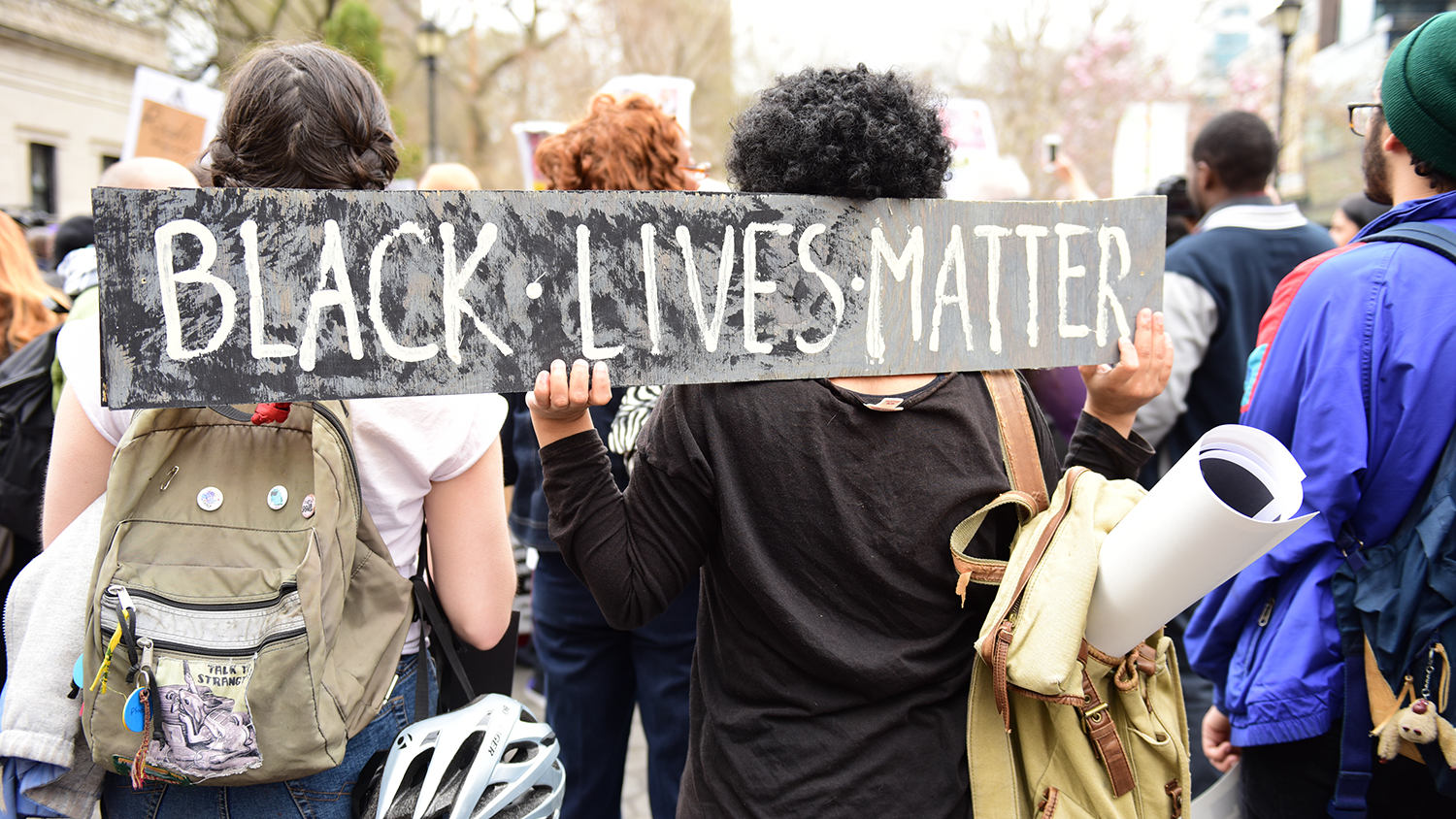 Students hold BLM poster